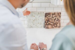 man showing woman tile samples